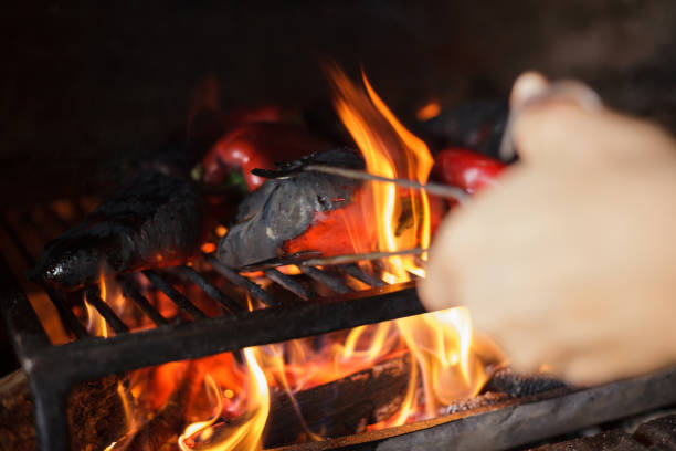 istock Preparing traditional Balkan's delicacy Ajvar, grilling paprika on an open flame 1162119496