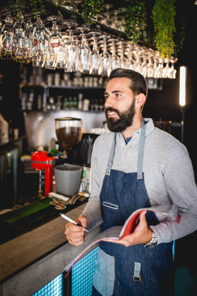 istock Young coffee-shop owner checking whether they have everything in stock 1162121009