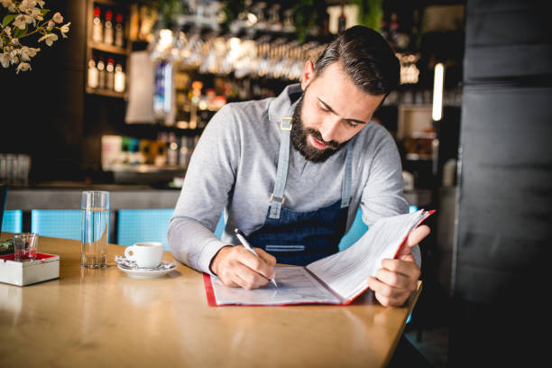 istock Young coffee-shop owner doing the accountant job 1162121012