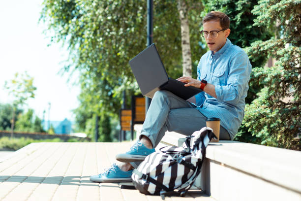istock Busy freelancer working on laptop while sitting in the park 1162121664