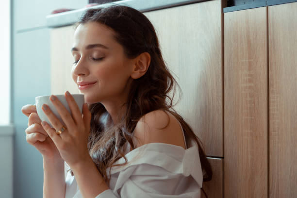 istock Beautiful young woman drinking freshly brewed coffee 1162121704