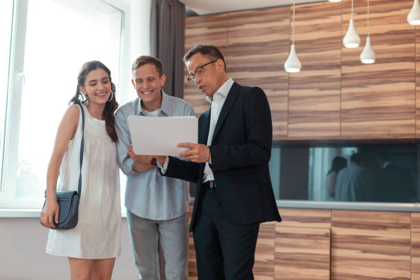 istock Couple feeling excited while speaking with real estate agent 1162121795