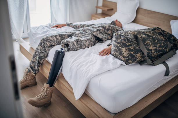 istock Disabled veteran US soldier lying alone in bedroom 1162121944