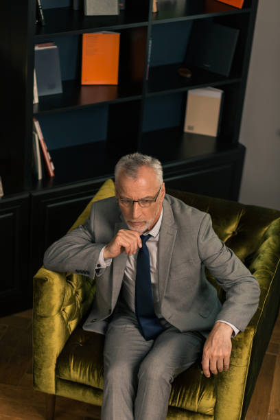 istock Thoughtful serious grey-haired man sitting in an armchair 1162122869