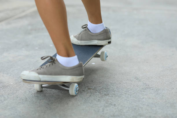 istock Female skateboarder skateboarding at skatepark 1162122909