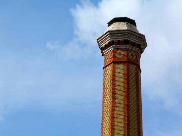 istock tall industrial chimney stack of yellow and red brick of octagonal base 1162123172