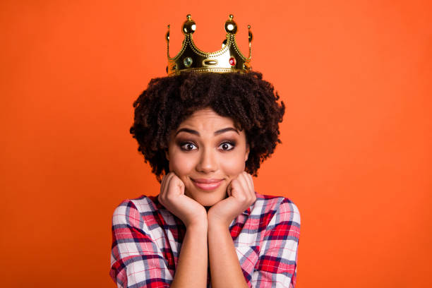 Close up photo of cute nice lady gold crown head famous person coronation wear casual plaid checkered shirt isolated orange bright background Close up photo of cute nice lady gold crown head famous person, coronation wear casual plaid checkered shirt isolated orange bright background princess crown tiara prom stock pictures, royalty-free photos & images