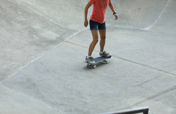 istock Female skateboarder skateboarding at skatepark 1162125608