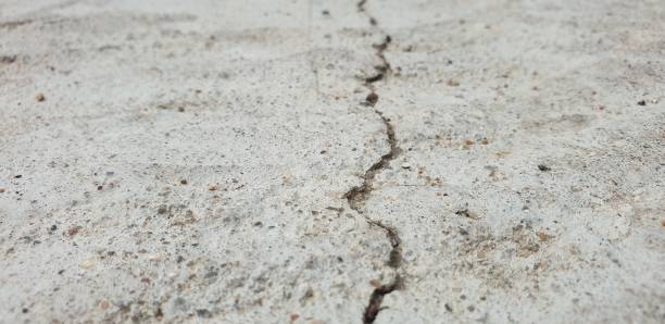 istock Crack in concrete. Cracked foundation. Cracked road. 1162126777
