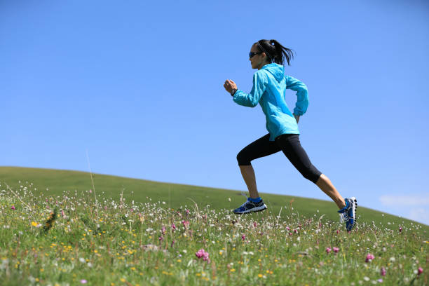 istock Woman ultramarathon trail runner running  on grassland mountain 1162127949