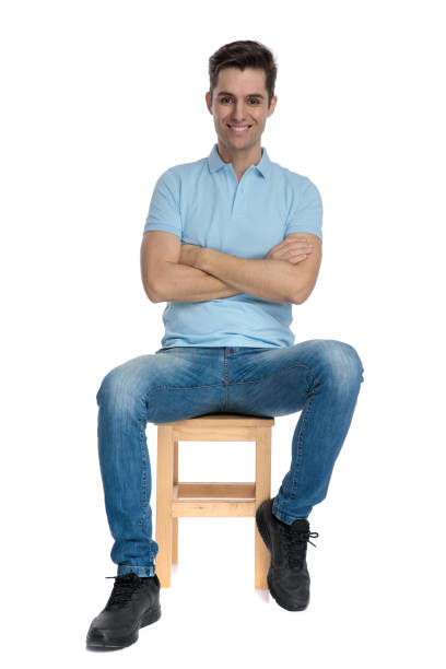istock Positive young man sitting with his arms folded and smiling 1162128561