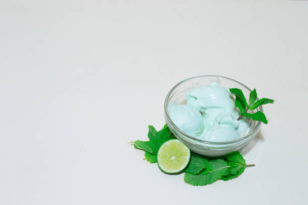 Lime and mint ice cream on white background