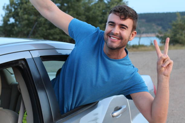 istock Car passenger showing peace sign during road trip 1162129730