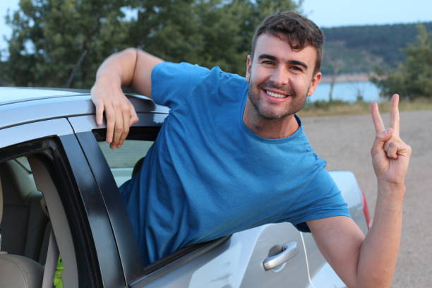 istock Car passenger showing peace sign during road trip 1162129741