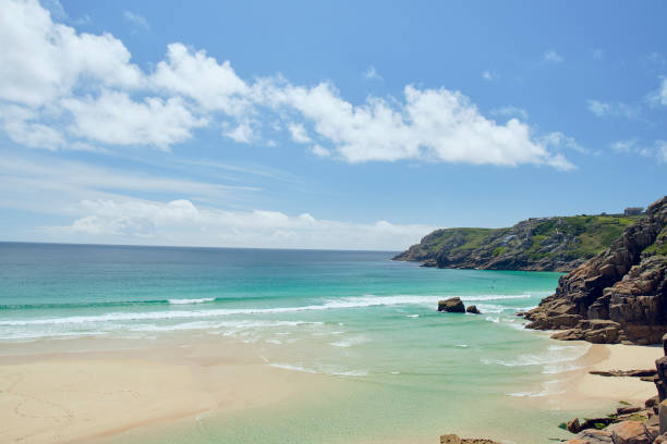 istock Low tide at Porthcurno, Cornwall on a bright sunny idyllic June day. 1162129885