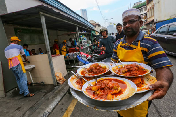 Transfer Road Roti Canai Pulau Pinang, Malaysia - July 05, 2019 : The famous roti canai with chicken and beef curry stall at Transfer Road. One of tourist attraction and the best place to breakfast in Penang. roti canai stock pictures, royalty-free photos & images