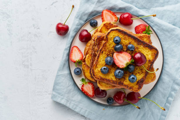 istock French toasts with berries, brioche breakfast, white background top view copy space 1162131639