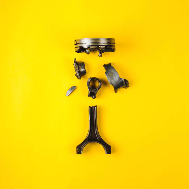 istock Old broken piston and connecting rod on yellow background 1162131869