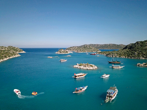Aerial photo of tourboats and yachts on turquoise bay in Mediterranean Turkey, Antalya; Kekova.