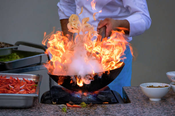 istock cook flambers vegetables in a pan 1162134694