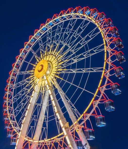 istock Low Angle View Of Illuminated Ferris Wheel Against Sky At Night 1162134699