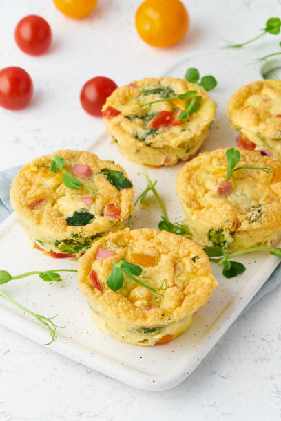 istock omelet with tomatoes and bacon, baked eggs with spinach and broccoli, closeup, vertical, keto, ketogenic diet 1162136900