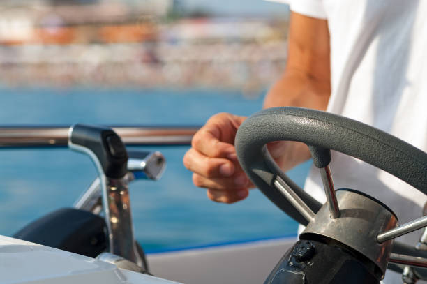 istock Man drives a yacht. 1162138050