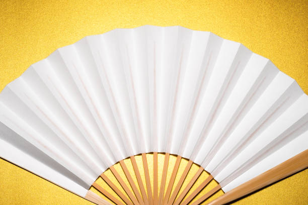 istock whtie Japanese foldable fan on golden background with copy space 1162138956