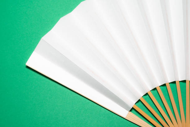 istock whtie Japanese foldable fan on green background with copy space 1162139072