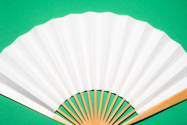 istock whtie Japanese foldable fan on green background with copy space 1162139125