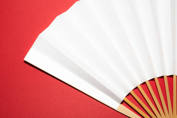 istock whtie Japanese foldable fan on red background with copy space 1162139272