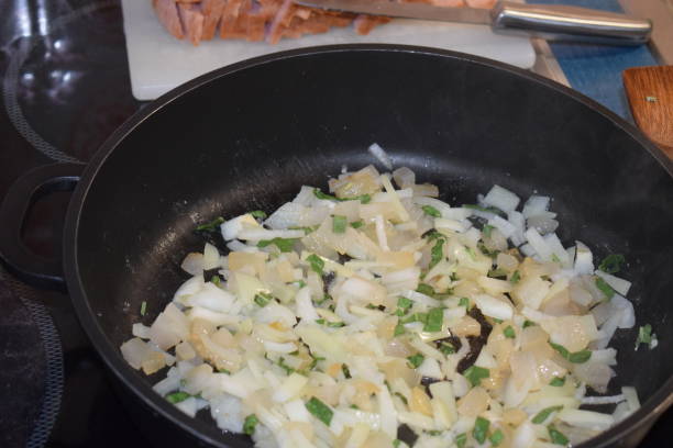 istock bacon and onions in frying pan 1162142593