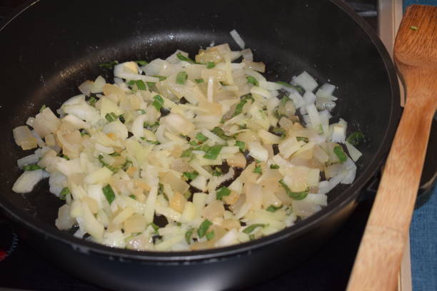 istock bacon and onions in frying pan 1162142788