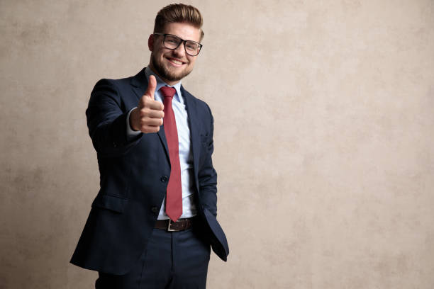 istock Joyful businessman smiling and gesturing ok 1162143267