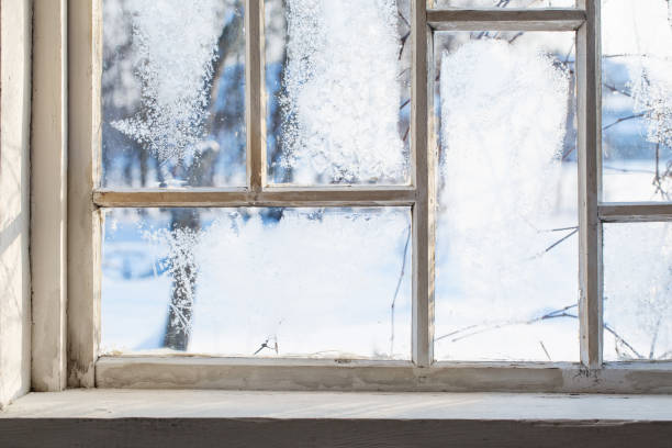 istock old wooden window with winter frost 1162144619