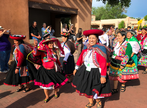 Santa Fe, NM: Exuberant Peruvian artists in traditional dress at the annual 2019 Folk Art parade on the historic Santa Fe Plaza. The free parade kicks off the annual International Folk Art Market (IFAM), where artists from over 100 countries participate.