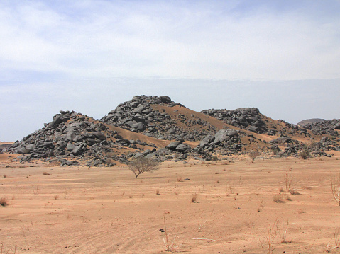 View of the Nubian desert, on the road between Karima and Atbara, in northen Sudan. The Nubian Desert is in the eastern region of the Sahara Desert, between the Nile and the Red Sea. The native inhabitants of the area are the Nubians, descendants of the ancient Nubian civilizations also called the Black Pharaohs.
