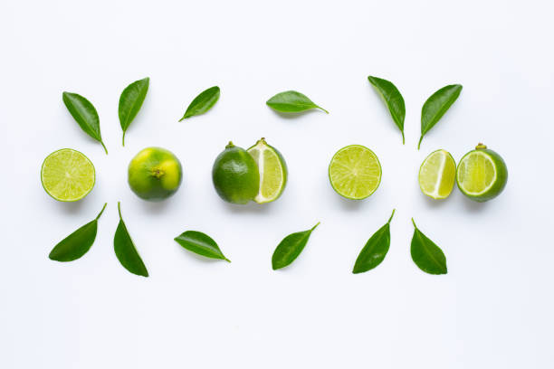istock Fresh limes with leaves isolated on white 1162146963