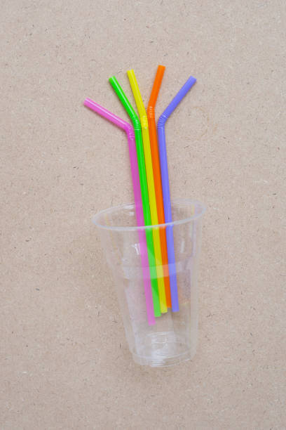 istock Plastic glass with straws on plywood 1162147276
