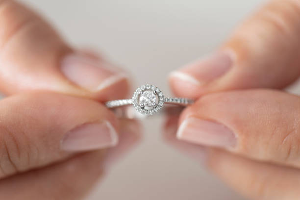 istock Woman holding a diamond ring 1162147949