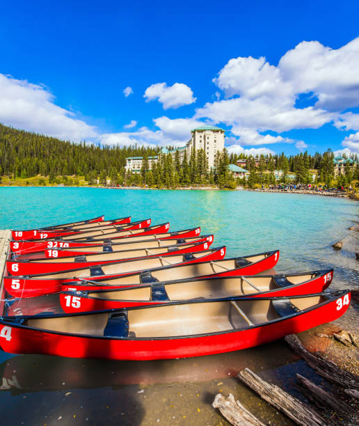Red canoes are moored to the coast