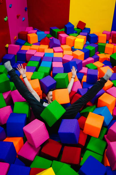 istock A young man or boy, father playing and jump in soft cubes in the 1162149028