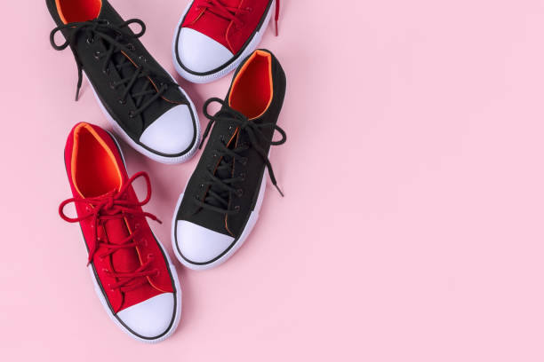 istock New red and black sneakers on pink background with copy space. 1162149790