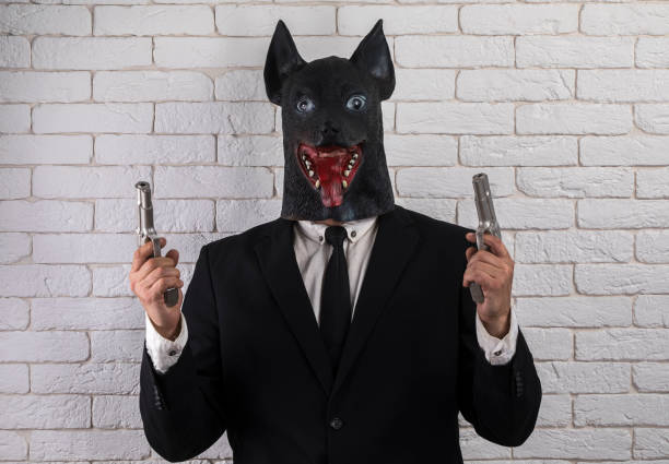 istock man in animal mask with a gun 1162150046