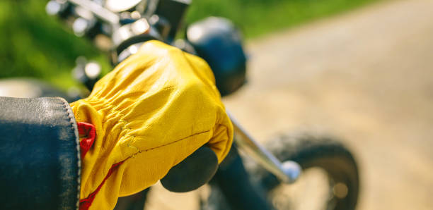 istock Biker's hand with gloves grabbing the handlebar 1162152198