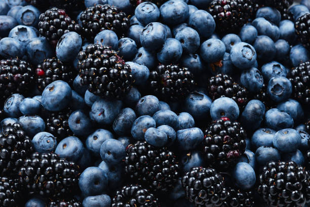 istock Blackberry and  blueberry background. Top view. 1162152256