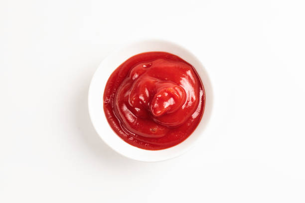 istock Ketchup in white plate on white background. 1162152321