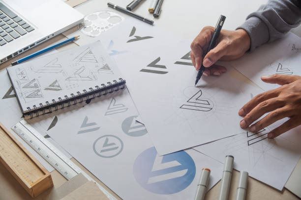 istock Graphic designer drawing sketch design creative Ideas draft Logo product trademark label brand artwork. Graphic designer studio Concept. 1162153146
