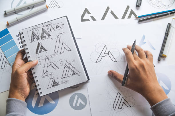 istock Graphic designer drawing sketch design creative Ideas draft Logo product trademark label brand artwork. Graphic designer studio Concept. 1162153149