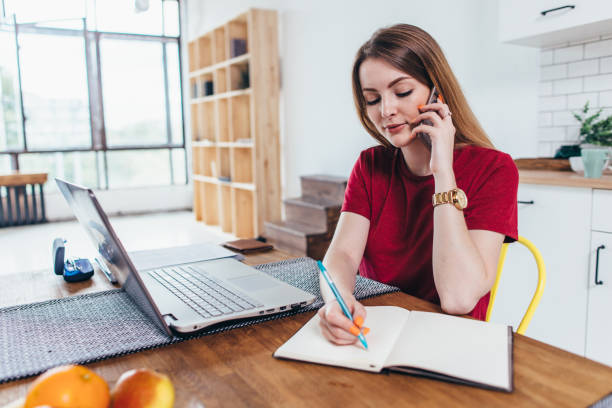 The Most Advanced Automation Technologies For Your Marketing Campaign 1 woman working at home write notes while talking on phone